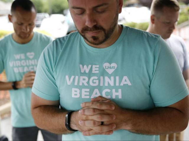 People gather to pray during a vigil in response to a fatal shooting at a municipal building in Virginia Beach, Va., Saturday, June 1, 2019. (AP Photo/Patrick Semansky)