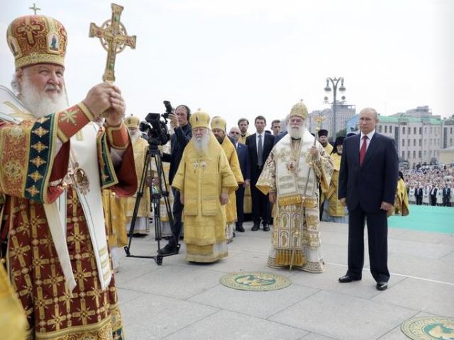 Russian Orthodox Church Patriarch Kirill, left, leads a religion service as Russian President Vladimir Putin, right, attends a ceremony marking the 1,030th anniversary of the adoption of Christianity.