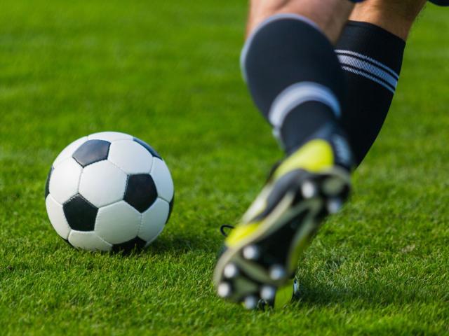 Person kicking a soccer ball 