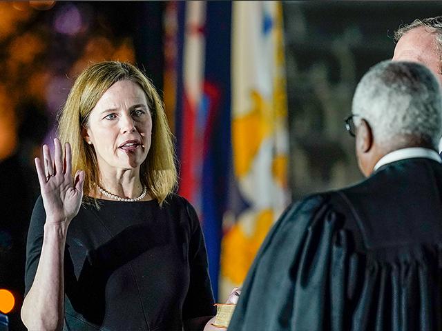 Supreme Court Justice Clarence Thomas administers the Constitutional Oath to Amy Coney Barrett on the South Lawn of the White House, Oct. 26, 2020, after Barrett was confirmed to be a Supreme Court justice by the Senate (AP Photo/Patrick Semansky)