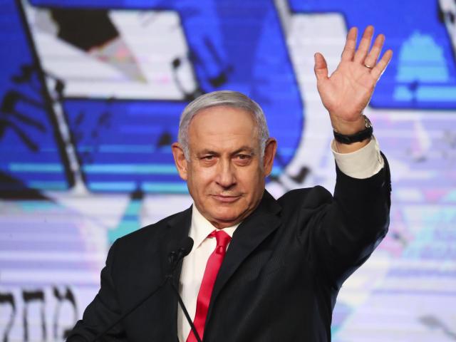 Israeli Prime Minister Benjamin Netanyahu waves to his supporters after the first exit poll results for the Israeli parliamentary elections at his Likud party&#039;s headquarters in Jerusalem, Wednesday, March. 24, 2021. (AP Photo/Ariel Schalit)
