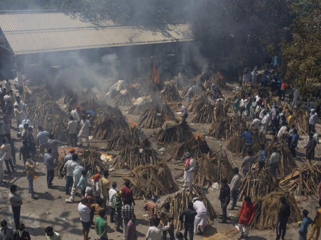 In this April 24, 2021, file photo, multiple funeral pyres of those who died of COVID-19. (AP Photo/Altaf Qadri, File)