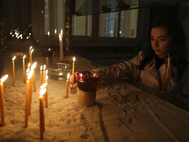 Faithful light candles prior to the Easter Resurrection Service  at the Patriarchal Cathedral of St. George in Istanbul, late Saturday, May 1, 2021. (Erdem Sahin/Pool via AP)