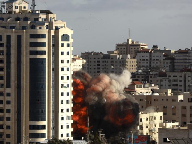 An Israeli air strike hits a building in Gaza City, Monday, May 17, 2021. (AP Photo/Hatem Moussa)