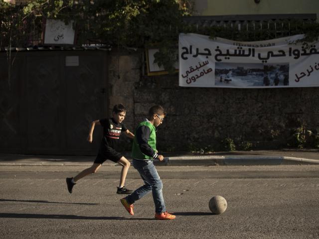 In this May 27, 2021, file, photo, Palestinian boys play soccer on their street in the Sheikh Jarrah neighborhood of eastern Jerusalem. (AP Photo/Maya Alleruzzo, File)