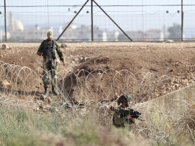 In this Sept. 12, 2021, file photo, Israeli soldiers take positions along the border between the northern West Bank near Jenin and Israel as they search for two Palestinians who broke out of a maximum-security prison. (AP Photo/Ariel Schalit, File)
