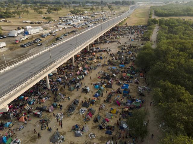 Migrants, many from Haiti, are seen at an encampment along the Del Rio International Bridge near the Rio Grande, Tuesday, Sept. 21, 2021, in Del Rio, Texas. (AP Photo/Julio Cortez)