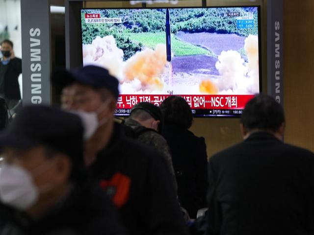 People watch a TV showing a file image of North Korea&#039;s missile launch during a news program at the Seoul Railway Station in Seoul, South Korea, Thursday, March 24, 2022. (AP Photo)