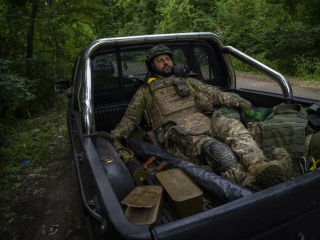 A Ukrainian serviceman pauses before going back to the frontline in the Donetsk oblast region, eastern Ukraine, Sunday, June 5, 2022. (AP Photo/Bernat Armangue)