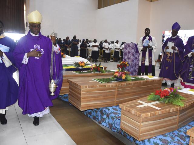 Mourners pay theirs respects to the victims killed at the St. Francis Catholic Church on June 5, during a funeral service in Owo, Southwest of Nigeria, Friday, June 17, 2022. (AP Photo/Rahaman A Yusuf)