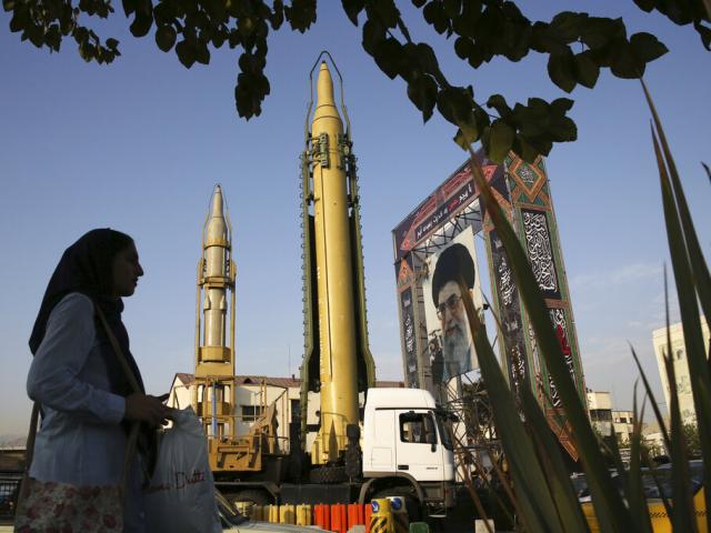 A Ghadr-H missle, center, a solid-fuel surface-to-surface Sejjil missile and a portrait of the Supreme Leader Ayatollah Ali Khamenei are on display in Iran. (AP Photo/Vahid Salemi, File)