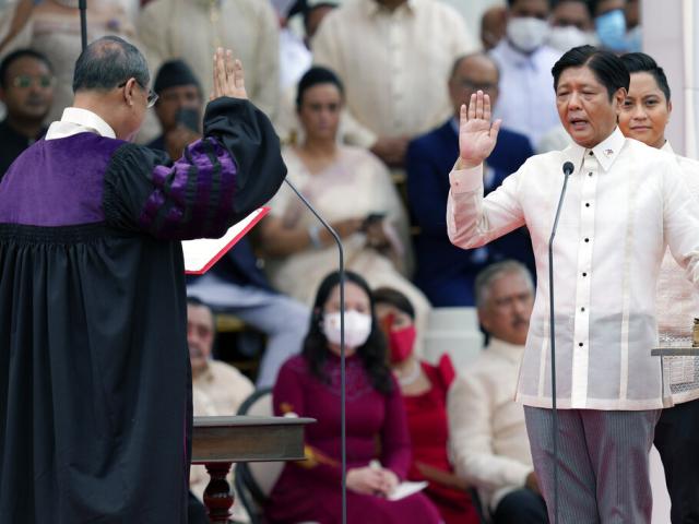 President-elect Ferdinand &quot;Bongbong&quot; Marcos Jr., right, is sworn in by Supreme Court Chief Justice Alexander Gesmundo during the inauguration ceremony at National Museum on Thursday, June 30, 2022 in Manila, Philippines. (AP Photo)