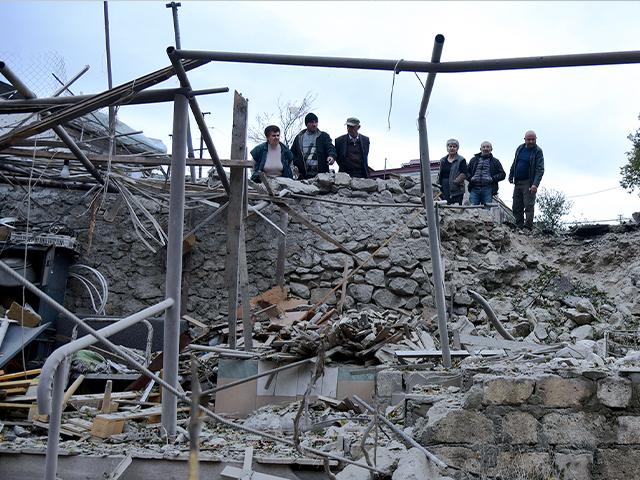 Men look at the damage in a residential area after shelling by Azerbaijan&#039;s artillery during a military conflict in self-proclaimed Republic of Nagorno-Karabakh, Sunday, Oct. 4, 2020.David Ghahramanyan/NKR InfoCenter PAN Photo via AP)