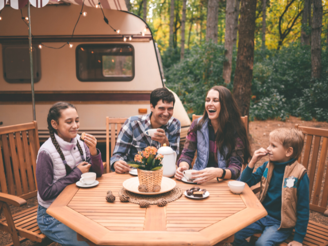 happy family in front of a camper