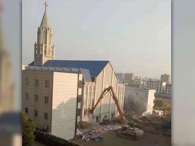 A church building in the Funan, Anhui region of China is torn down on the order of Chinese government officials while the congregation worships inside. (Image credit: China Aid)