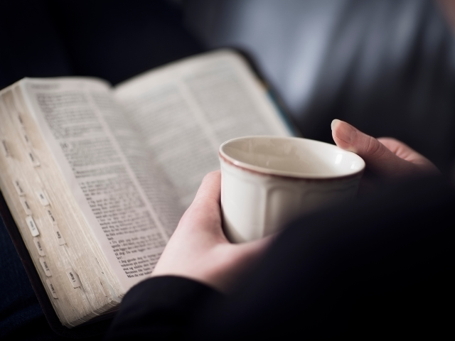 reading the Bible with a cup of coffee