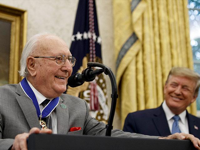 Former NBA basketball player and coach Bob Cousy, of the Boston Celtics, speaks as President Donald Trump smiles during a Presidential Medal of Freedom ceremony for Cousy, in the Oval Office, Thursday, Aug. 22, 2019, in Washington. (AP Photo/Alex Brandon)