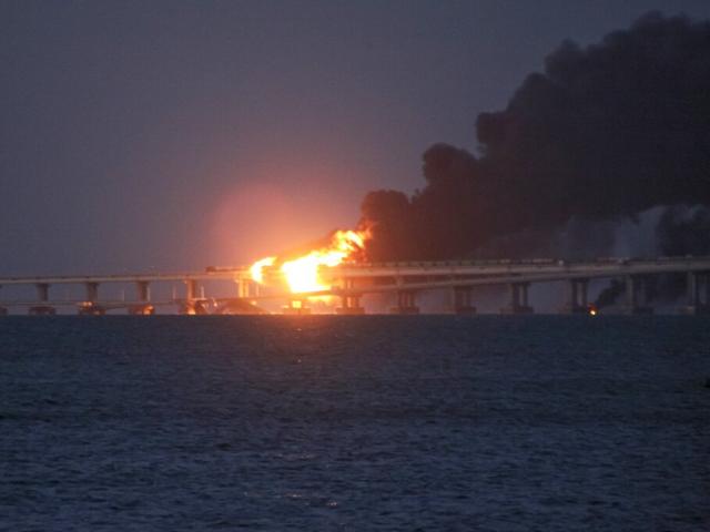Flames and smoke rise from the Crimean Bridge over the Kerch Strait in Crimea, Saturday, Oct. 8, 2022. The bridge is a key supply artery for Moscow&#039;s faltering war effort in southern Ukraine. (AP Photo)