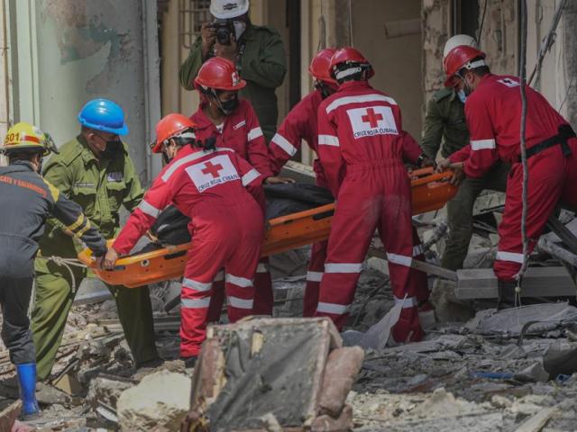 Rescuers recover a body at the site of Friday&#039;s deadly explosion that destroyed the five-star Hotel Saratoga, in Havana, Cuba, Saturday, May 7, 2022. (AP Photo/Ramon Espinosa)