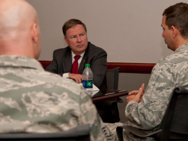 US Rep. Doug Lamborn (R-COLO) listens to the concerns of two airmen during a visit to Peterson Air Force Base . Image courtesy: Peterson Air Force Base