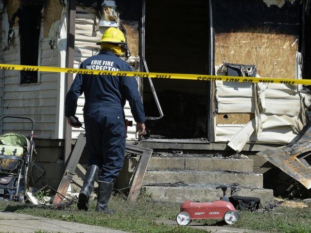 Erie Bureau of Fire Inspector investigates a fatal fire at 1248 West 11th St. in Erie, Pa, on Sunday, Aug. 11, 2019 (Greg Wohlford/Erie Times-News via AP)
