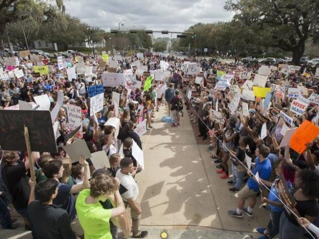 Students gather on the steps of the old Florida capitol protesting gun violence in Tallahassee, Fla.