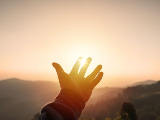 hand and sunrise