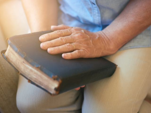 hand on an old Bible