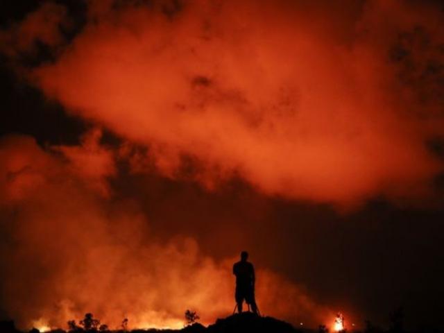 Peter Vance, 24, photographs lava erupting in the Leilani Estates subdivision near Pahoa, Hawaii Friday, May 18, 2018. AP Photo.