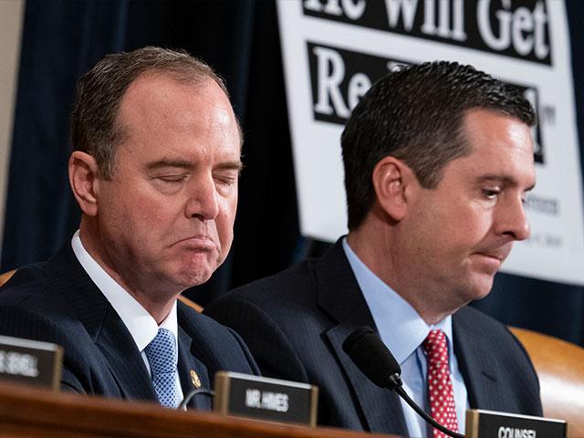 House Intelligence Committee Chairman Adam Schiff, D-Calif., left, responds to Rep. Devin Nunes, R-Calif, the ranking member, right, as the panel holds the first public impeachment hearings of President Trump (AP photo)