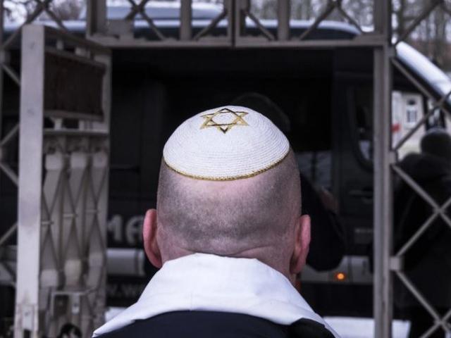 A man with a Jewish yarmulke walks in front of the camp entrance after a wreath-laying ceremony on occasion of the international Holocaust remembrance day in the forme Nazi concentration camp Buchenwald near Weimar, Germany.
