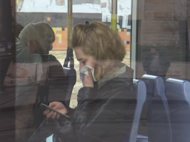 A passenger on Jerusalem&#039;s light rail covering her mouth and nose. 15 March 2020.