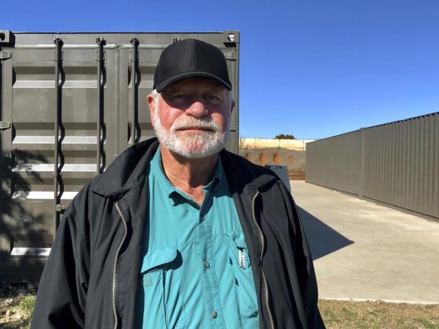 Jack Wilson, 71, poses for a photo at a firing range outside his home in Granbury, Texas, Monday, Dec. 30, 2019. (AP Photo/Jake Bleiberg)