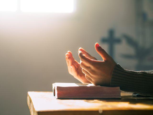 hands open on bible