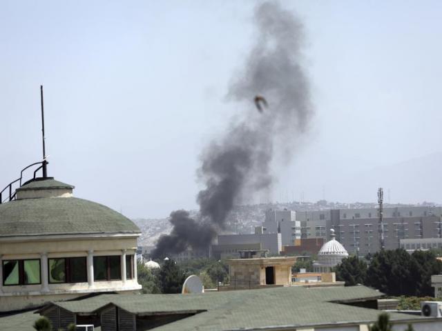 Smoke rises next to the U.S. Embassy in Kabul, Afghanistan, Sunday, Aug. 15, 2021. (AP Photo/Rahmat Gul)