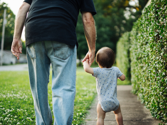 father-holding-toddler-hand-walking