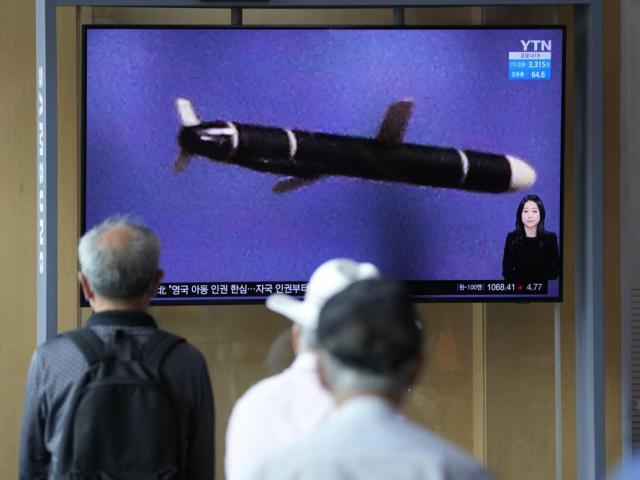 People watch a TV screen showing a news program showing a North Korean handout photo that says, &quot;North Korea&#039;s long-range cruise missiles tests.&quot; (AP Photo/Lee Jin-man)