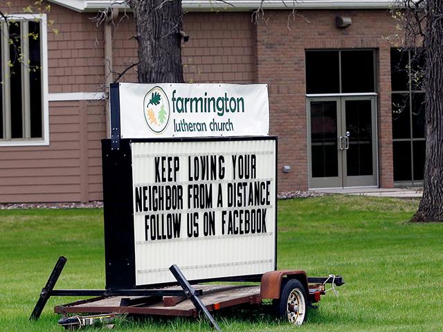 A church marquee has a take on the biblical &quot;love your neighbor&quot; and social distancing Wednesday, May 13, 2020 in Farmington, Minn. due to the coronavirus pandemic. (AP Photo/Jim Mone)