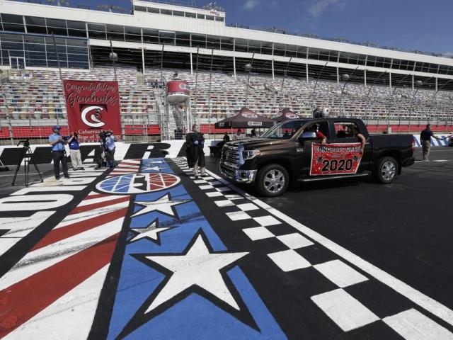 Graduating seniors drive across the start-finish line at the Charlotte Motor Speedway in Concord, N.C.,(AP Photo/Gerry Broome)