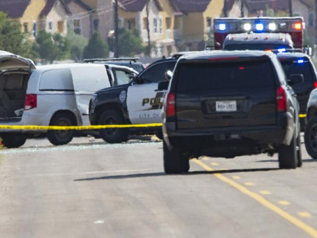 Police and sheriff&#039;s deputies surround a white van in Odessa, Texas, Saturday, Aug. 31, 2019 (Tim Fischer/Midland Reporter-Telegram via AP)