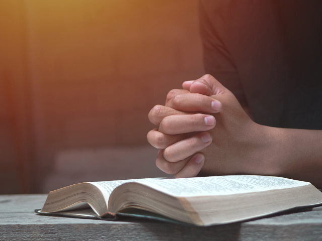 praying-hands-atop-bible