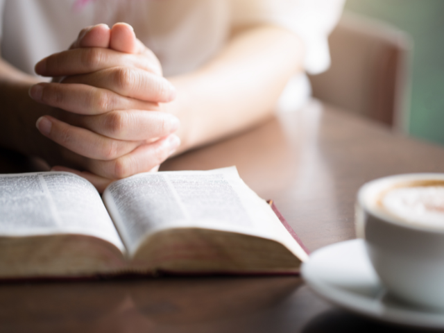 praying with a cup of hot tea and a Bible