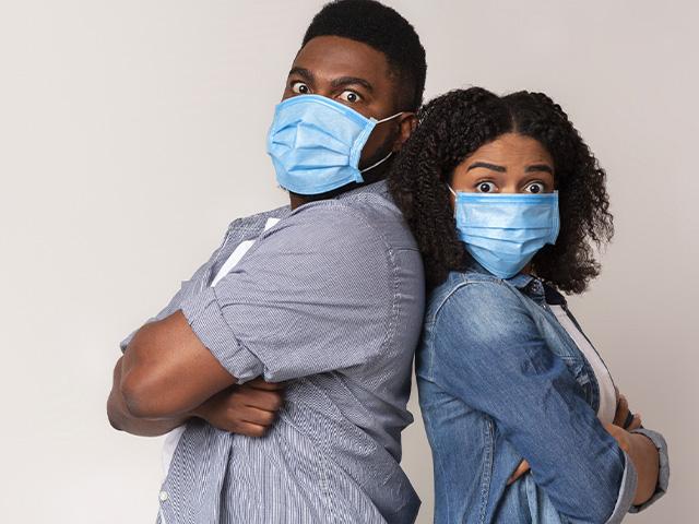 Frustrated couple wearing masks in quarantine