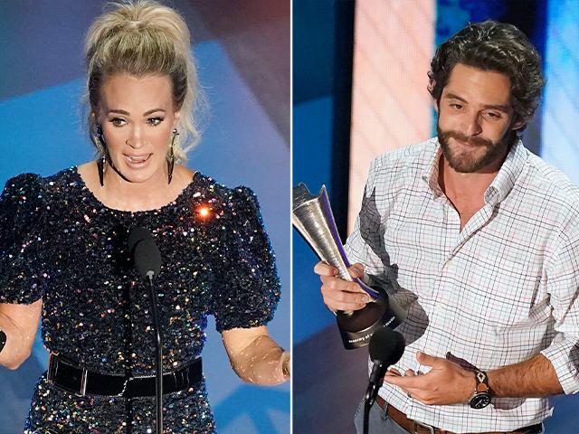 Carrie Underwood, left, and Thomas Rhett accept their entertainer of the year awards during the 55th annual Academy of Country Music Awards at the Grand Ole Opry House on Wednesday, Sept. 16, 2020, in Nashville, Tenn. (AP Photo/Mark Humphrey)