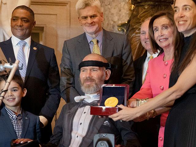 Congressional Gold Medal presented to amyotrophic lateral sclerosis (ALS) advocate and former National Football League (NFL) player, Steve Gleason, in Statuary Hall on Capitol Hill, Jan. 15, 2020. (AP Photo/Manuel Balce Ceneta)