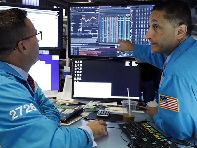 Specialists Paul Cosentino, left, and Jeffrey Berger work on the floor of the New York Stock Exchange, Monday, Aug. 5, 2019. (AP Photo/Richard Drew)