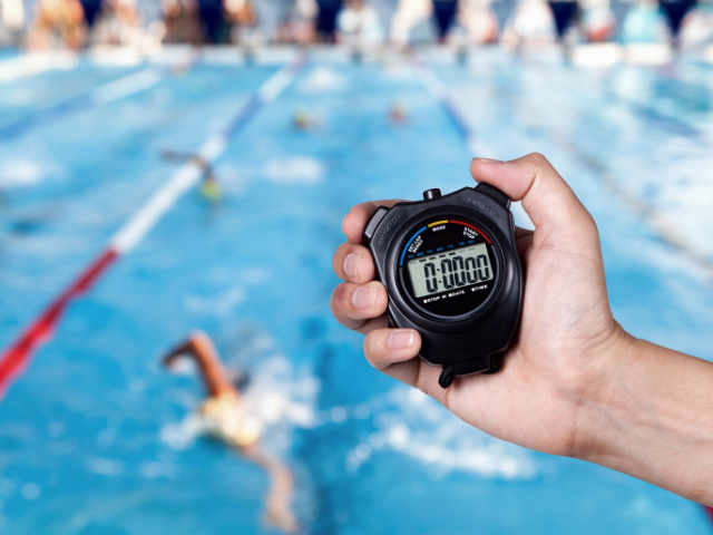 swim meet and person with stopwatch
