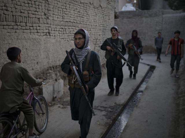Taliban fighters patrol a neighborhood in search for a man accused in a stabbing incident, in Kabul, Afghanistan. (AP Photo/Felipe Dana)