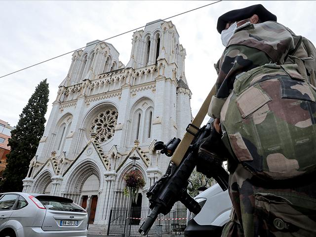 A soldier patrols outside Notre Dame church in Nice, southern France, Thursday, Oct. 29, 2020. An attacker armed with a knife killed three people inside a church in the Mediterranean city of Nice (Eric Gaillard/Pool via AP)