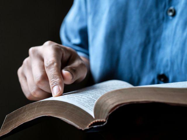 reading bible, pointing at words